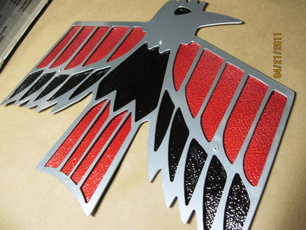Pontiac emblem in Super Chrome, Ink Black and Wilder Red over Super Chrome