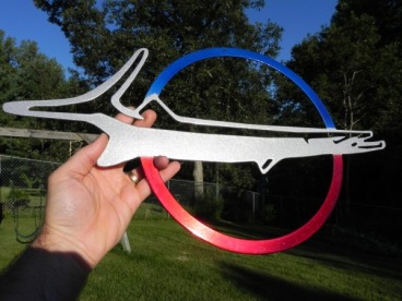 Barracuda emblem sign in Blue Odyssey and Wilder Red over Super Chrome with Alien Silver barracuda
